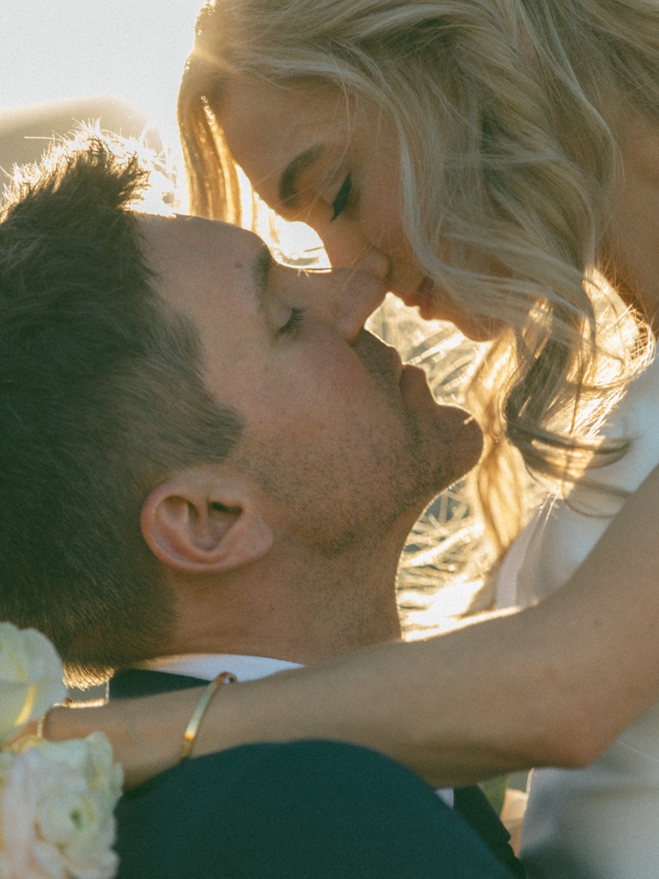 Couple almost kissing in golden backlight