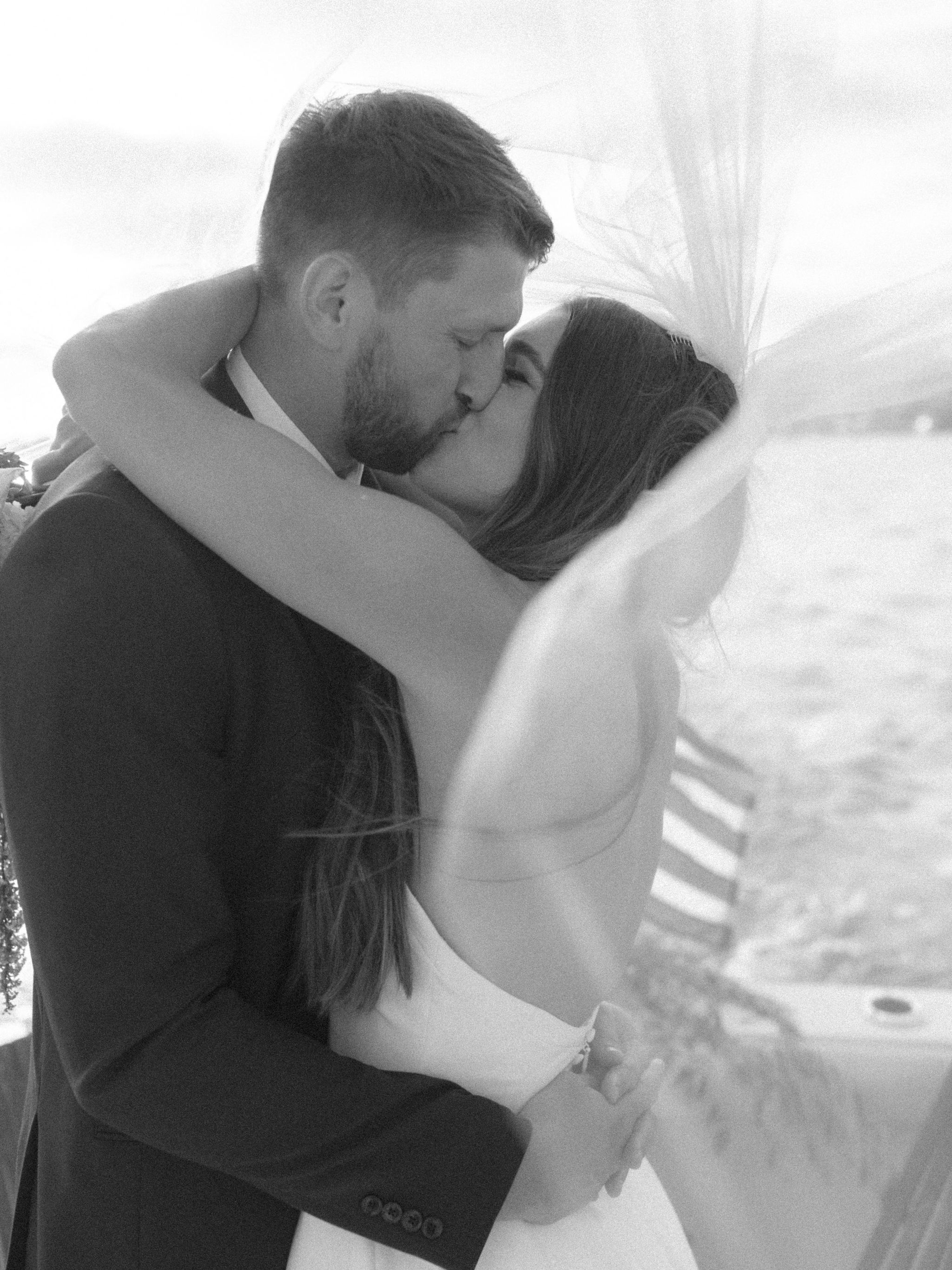 Couple kissing under veil