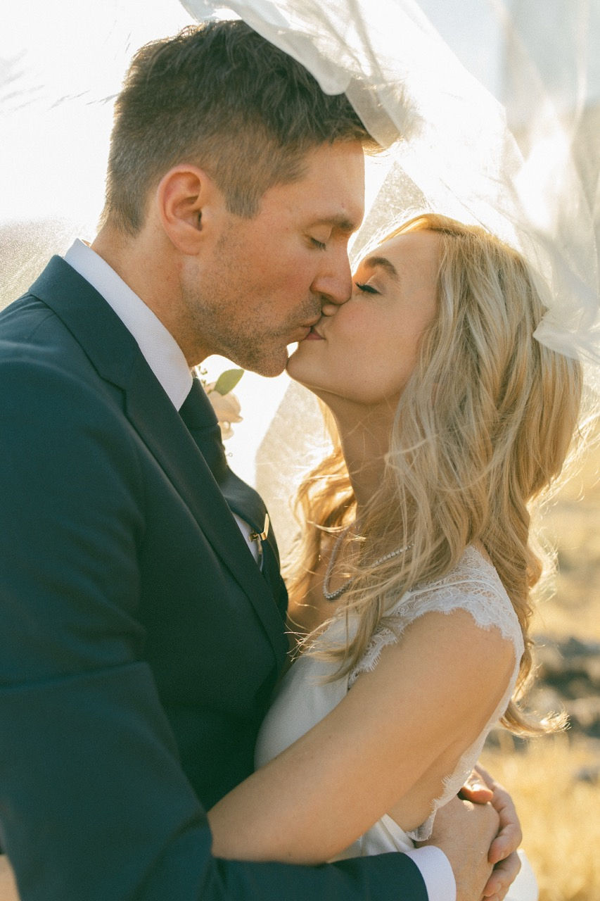Close kiss under veil in warm light