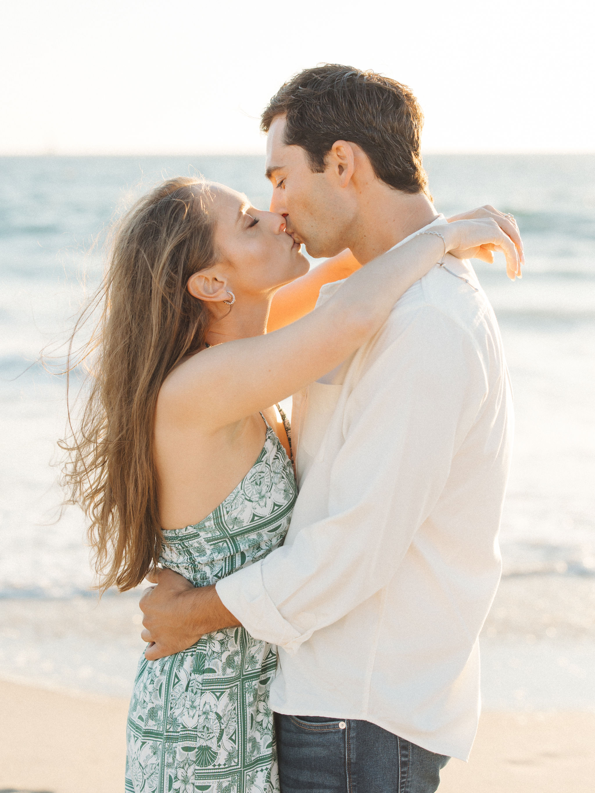Couple kissing at beach sunset