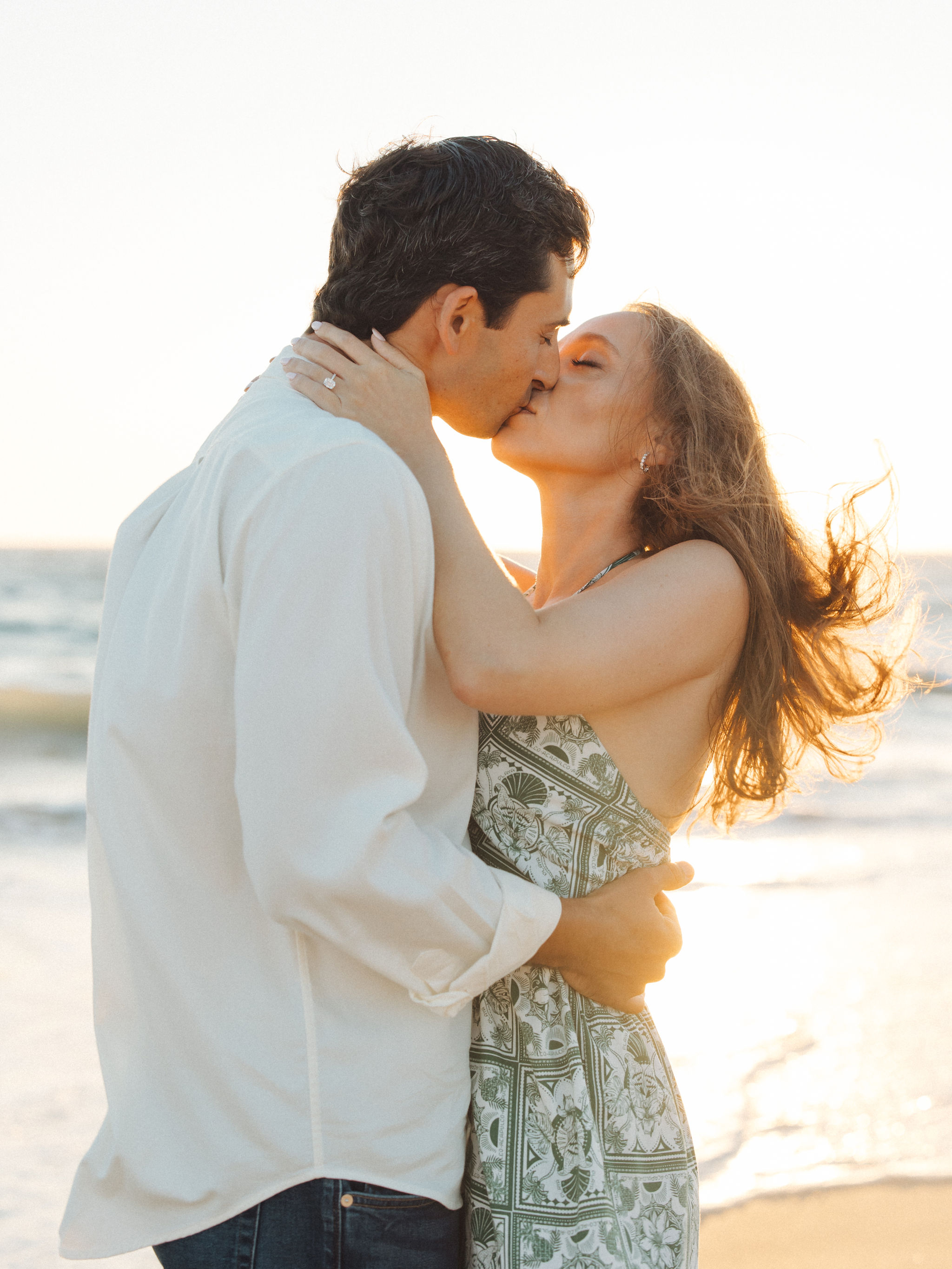 Couple at sunset after proposal